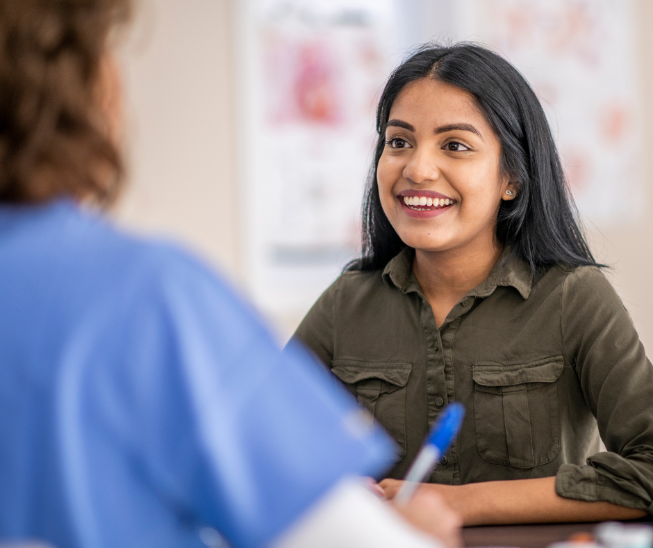 young woman speaking to healthcare provider