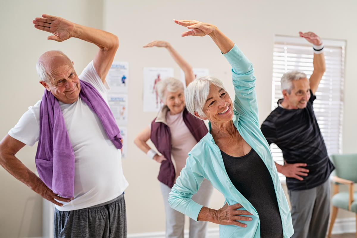 Mature men and women stretching and staying active