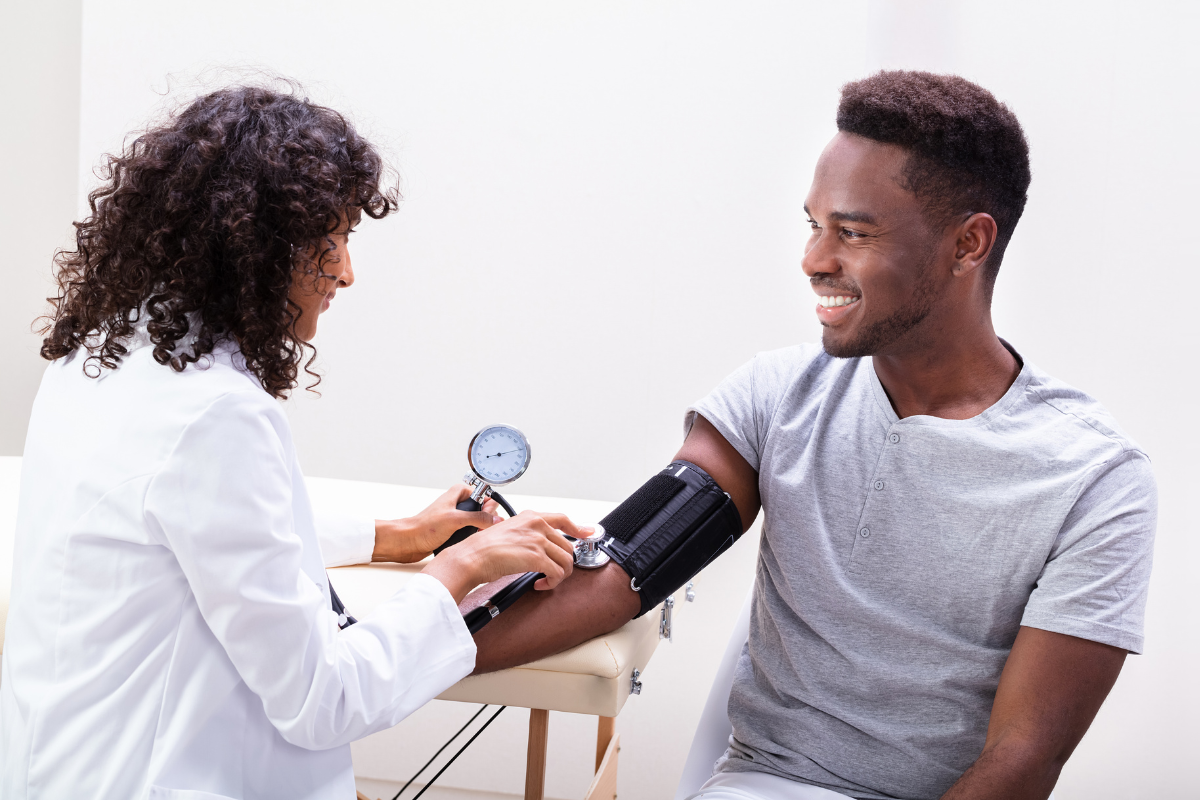 Young man having blood pressure taken