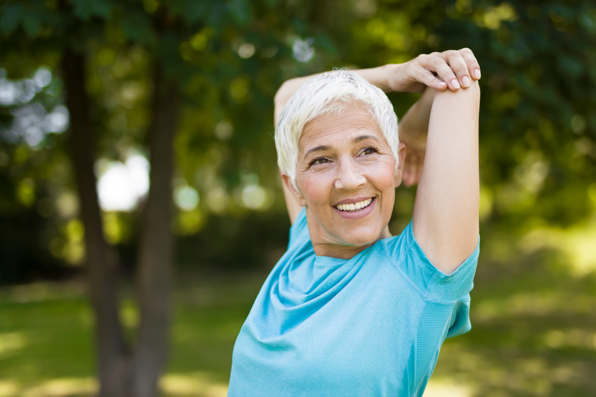 Healthy mature woman stretching after a workout