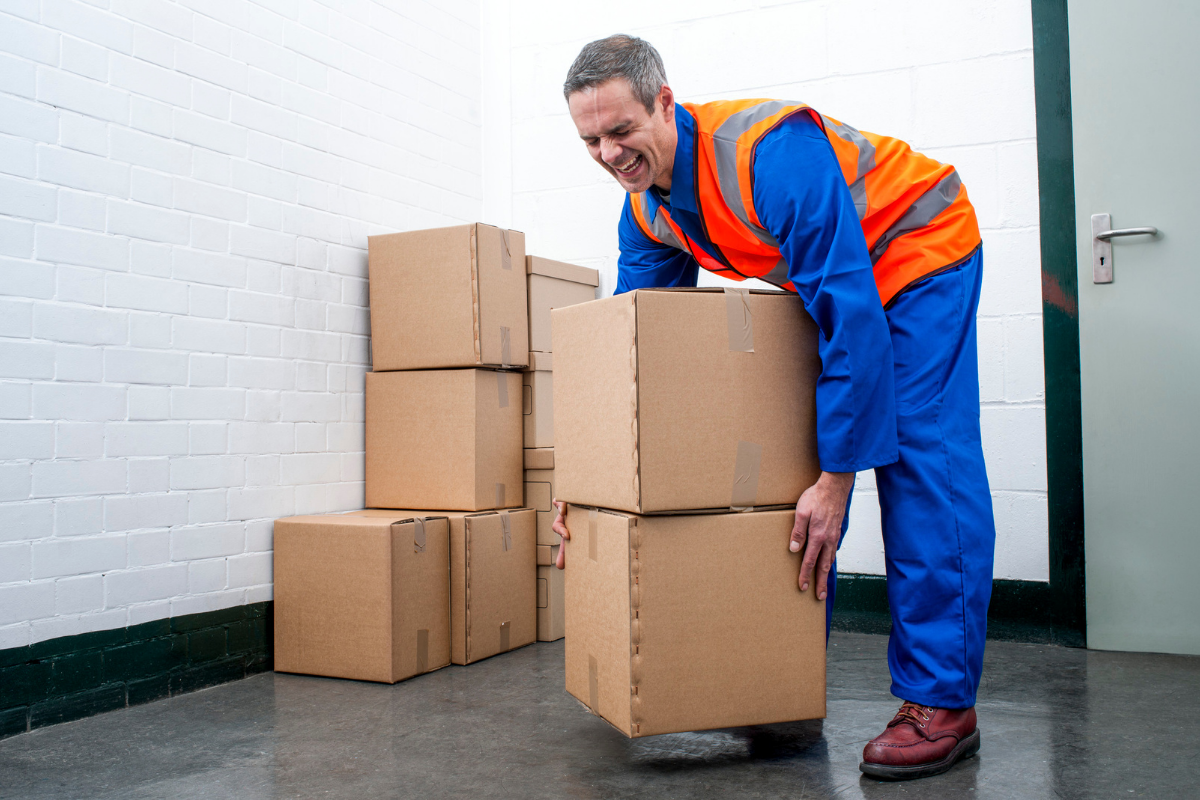 Man improperly lifting boxes and hurting back