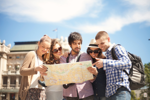 Friends traveling abroad and looking at a map together