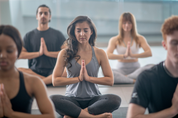 Group of people in a yoga class practicing meditation
