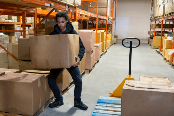 Man correctly lifting a box and using a cart to transport it