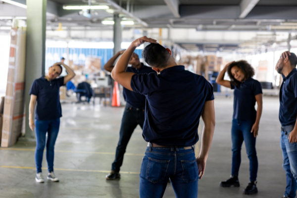 Manager leading team in stretches at the beginning of the shift
