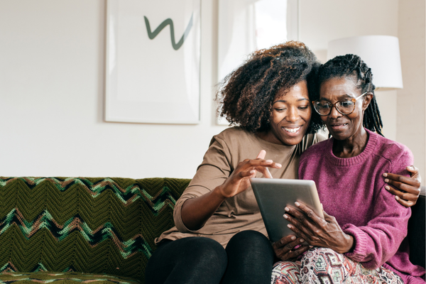 Caregiver and her loved one looking at resources and benefits for seniors