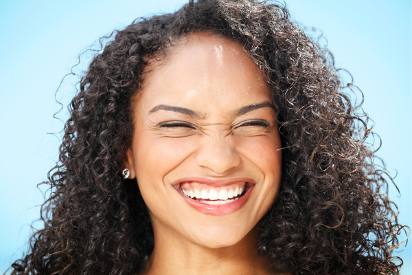 Woman with big, beautiful smile and no jaw pain