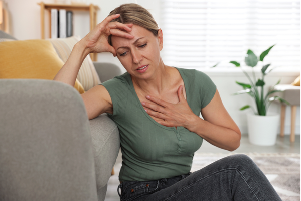 Woman experiencing symptoms of perimenopause, including hot flashes and palpitations