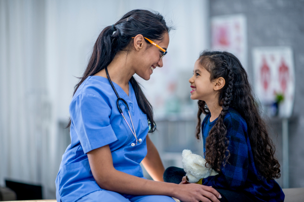 Healthcare provider with smiling child patient