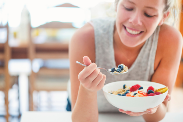 Woman eating healthy, fiber-rich meal after workout
