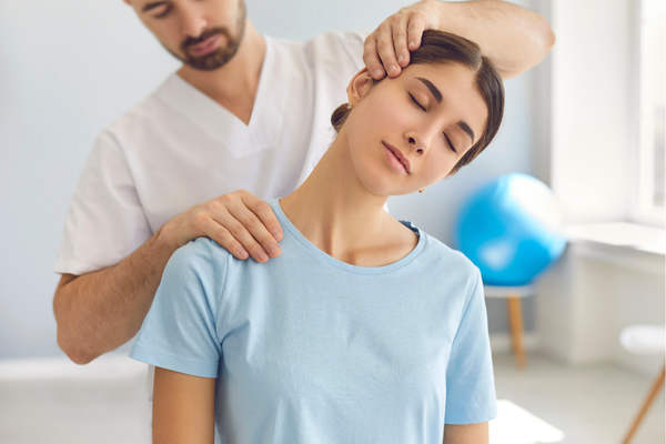 Young woman getting chiropractic relief for neck pain