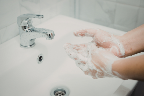 Person thoroughly washing hands to keep from getting the flu