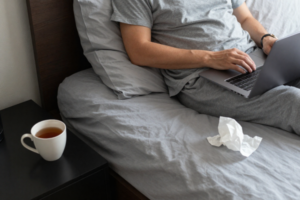 Person working from home while they recover from the flu