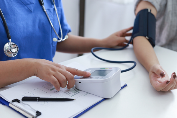 Woman having her blood pressure checked by provider