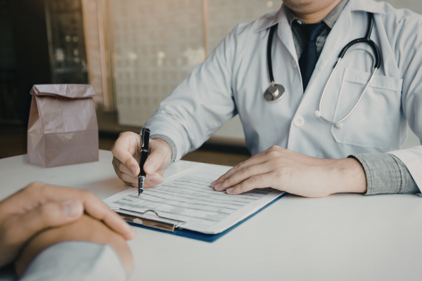 A doctor performing a Brown Bag Review, part of safe medication practices, with his patient