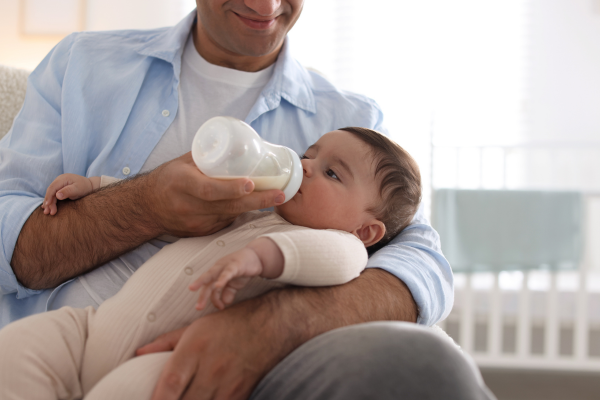Father feeding infant