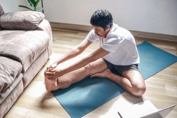 Man doing stretches at home to prevent repetitive strain injuries