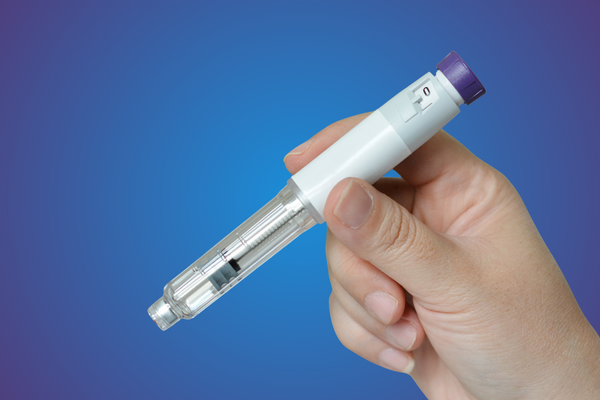 A healthcare provider holding a GLP-1 injection pen